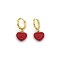 Detailed view of elegant gold hoop earrings with vibrant red heart-shaped pendants - Red