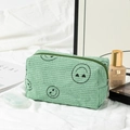 Light green corduroy makeup bag with black embroidered smile patterns and zipper - Green Heart-Eye Medium Makeup Bag