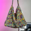 Detail of floral knit tote bag featuring purple and yellow patterns and GUAN label - Purple Large Floral