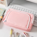 Pink double-layer stationery bag with zipper closure shown on a white desk setup - Pink