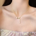 Elegant gold tulip bud necklace with pink-white flower pendant and pearl drop on model - Tulip Pearl Pendant Necklace (X2050) / Pink Gold