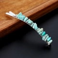 Close-up of turquoise crystal hair clip on a wooden tray with silver metal base - Amazonite with Silver Clip