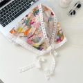 Detailed view of a vintage floral cotton headscarf with delicate white lace trim - Crayon Floral