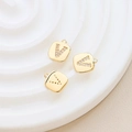 Detailed macro view of gold-plated square letter V pendants with zircon inlay craft - Letter V