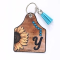 Faux leather ear tag keychain with sunflower print, letter y, and blue tassel detail - Letter Y