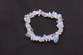 Natural light blue and white crushed stone bead bracelet on black textured fabric - Opal
