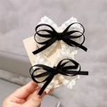 Pair of girls' black ribbon and white floral lace bow hair clips for sweet styling - Black Lace Bow Pair