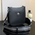 Black pebble leather crossbody bag with wide geometric strap and silver rotary buckle hardware - Black