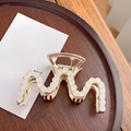 Elegant gold wavy hair claw clip featuring rows of white pearls on a minimalist wood base - M-Shaped Claw Clip - 8.7cm