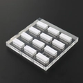 Macro shot of 12 white U-shaped acrylic ring display stands on a clear base - 12 Slots Clear Base White Velvet 12*12CM