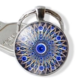 Detail of the blue evil eye mandala pendant keychain with metallic ring on a white surface - Mandala Blue Eye (JY006346-7)