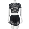 Detail of black lace two-piece set featuring floral hollow-out texture on crop top and skirt - S / Black