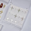 Detail view of cross-shaped nail art charms with rhinestones and pearls on display card - Silver Cross Style (MD-012) / Box Packaging