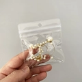 Portable PVC jewelry bag containing gold metal hoop earrings with white pearls - 25 Micron 8.5x9.5cm Perforated Resealable / 100 Pcs/Pack