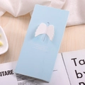 Light blue 3D wing greeting card on a wooden table with inspiring English quote - 3D Wings / Blue