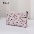 Close-up of pink geometric makeup bag featuring black triangular patterns and smooth zipper - Lattice Pink