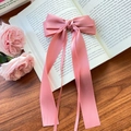 Pink satin ribbon bow hair clip with long streamers on a vintage book with pink roses - Deep Pink