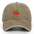 Macro detail of red cherry embroidery on vintage washed cotton khaki baseball cap - Khaki