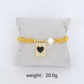 Bohemian gold beaded bracelet with a large white pearl and black heart charm - Black Zirconia Heart Charm Bracelet (Gold)