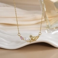 Detail of bird pendant necklace with pearl and pink zircon on a ceramic tray - FN0131 Pearl Pink Gemstone Bird