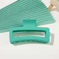 Detail shot of a mint green matte rectangular hollow hair claw clip for women's hair styling - 12cm XL Square - Mint Green