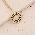 Detailed close-up of 18K gold-plated eye pendant necklace with micro-pave cubic zirconia - Black