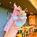 Pink liquid quicksand keychain in Mickey shape with glitter, pearls, and golden bell charm - White Luminous Mickey Head
