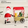 Père Noël poussant un chariot rouge avec cadeaux et ours, décoration de Noël en métal - Charrette du Père Noël