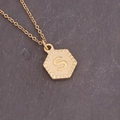 Macro detail of hexagonal gold pendant with letter S engraving on a slim chain - Letter S (19#S)