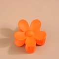 Top view of a vibrant orange matte flower hair claw clip with metal spring on beige background - Individual Packaging / Orange Red