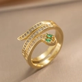 Vintage gold snake ring featuring clear zircons and emerald green gemstone eyes - Gold
