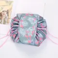 Detail of flamingo print drawstring makeup bag with velcro flap closure and pink cords - Blue Flamingo