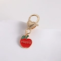 Detailed close-up of golden apple keychain with lobster clasp and Happy engraving - Letter Apple