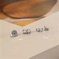 Detailed macro view of S925 sterling silver earring backs in 4mm and 5mm sizes - 4mm / White Gold
