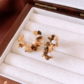 Detail of flower earrings with tiger eye stone and pearls on white velvet box - Gold/Brown (925 Silver Pin)