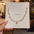 Double-layered pearl necklace with a vintage gold coin pendant on a white display card - HSLX977 Gold-Pearl Chain Retro Coin Portrait