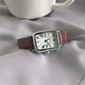 Detailed macro view of vintage square watch with brown leather strap and Roman numerals - Silver Case Brown Strap