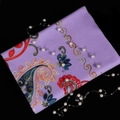 Detail of purple pashmina scarf with colorful floral paisley embroidery and pearl necklace - Light Purple