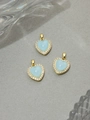 Close-up of light blue resin heart pendant with gold plating and white zircon border - Lake Blue