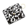 Detail of cow print leather card holder with gold snap button and metal keychain - B3 Large Cow Print