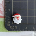 Mini resin Santa Claus charm for DIY crafts shown with metric ruler for size reference - 10-Curly Beard Santa Claus Head