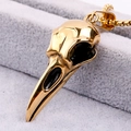 Detailed macro view of a golden eagle skull pendant with a polished metallic finish - Antique Gold Finish (No Chain)