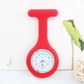 Detail view of a red silicone nurse fob watch with quartz movement and heart cross logo - Red