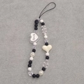 Macro detail of beaded phone charm featuring black and white acrylic heart-shaped beads - Love Heart Phone Chain