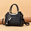 Black woven leather crossbody bag with gold ring handles and quilted texture design - Black