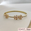 Pink clover open bangle in gold finish with sparkling zircon accents and size markers - 55x57.9mm / Pink