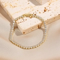 Gold tennis bracelet with square-cut white zircons on a champagne silk background - Gold Square Zirconia Tennis Bracelet (0070-2)