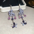 Detail view of silver drop earrings with purple butterfly crystals and crescent moons - Purple