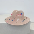 Detailed view of hand-painted colorful splatters on natural woven straw sun hat surface - M / Dusty Pink (Graffiti Splatter)