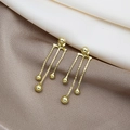 Elegant gold tassel earrings with triple chains and beads on a beige silk background - Gold Triple Chain Tassel Earrings (E4417)